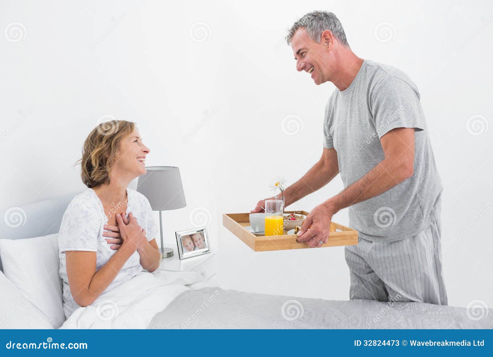 Loving Husband Bringing Breakfast In Bed To Wife Stock Photos
