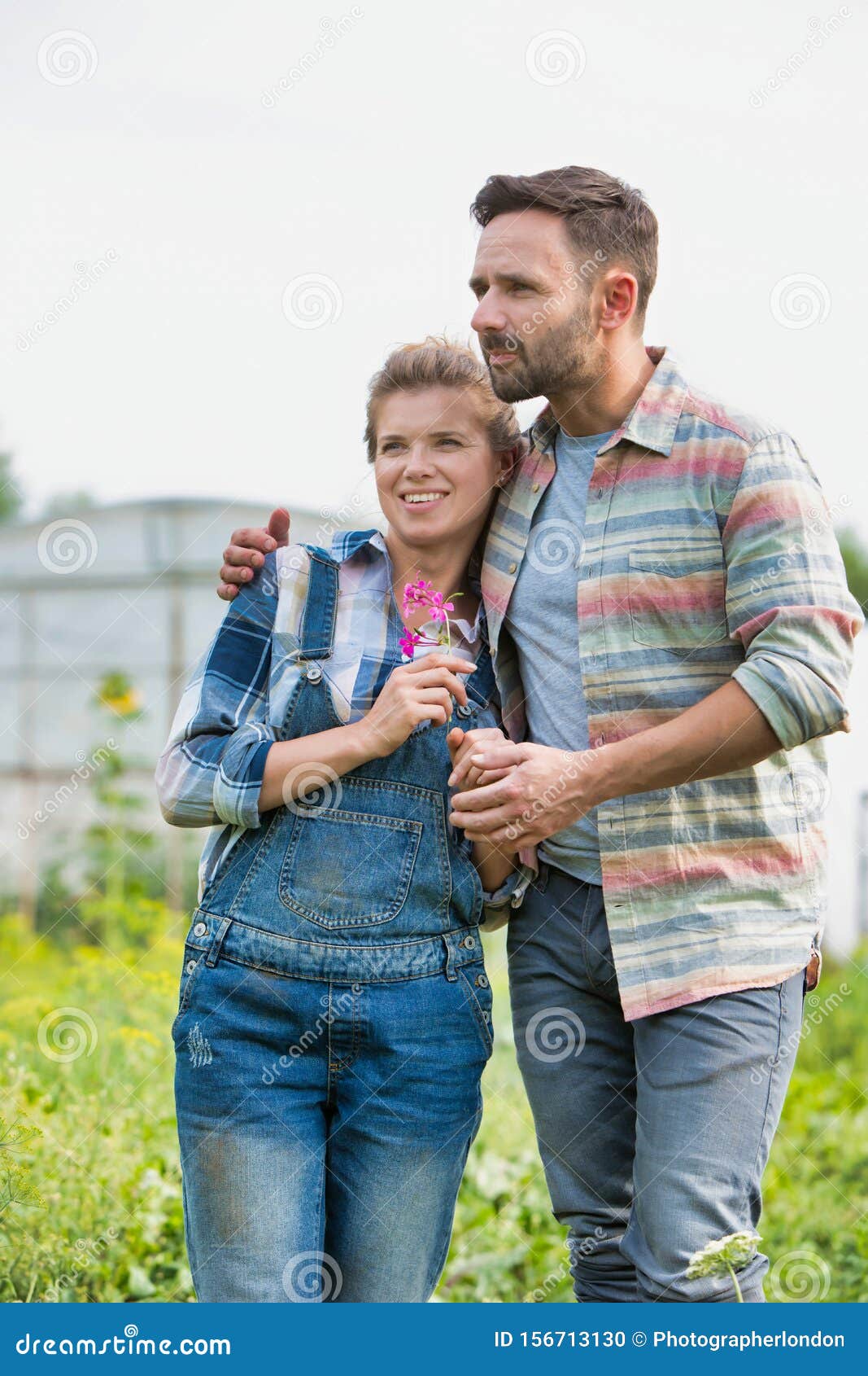 Picked Up A Husband For Farming Rear Photo of a Loving Husband and Wife Farmers Looking Locing Over