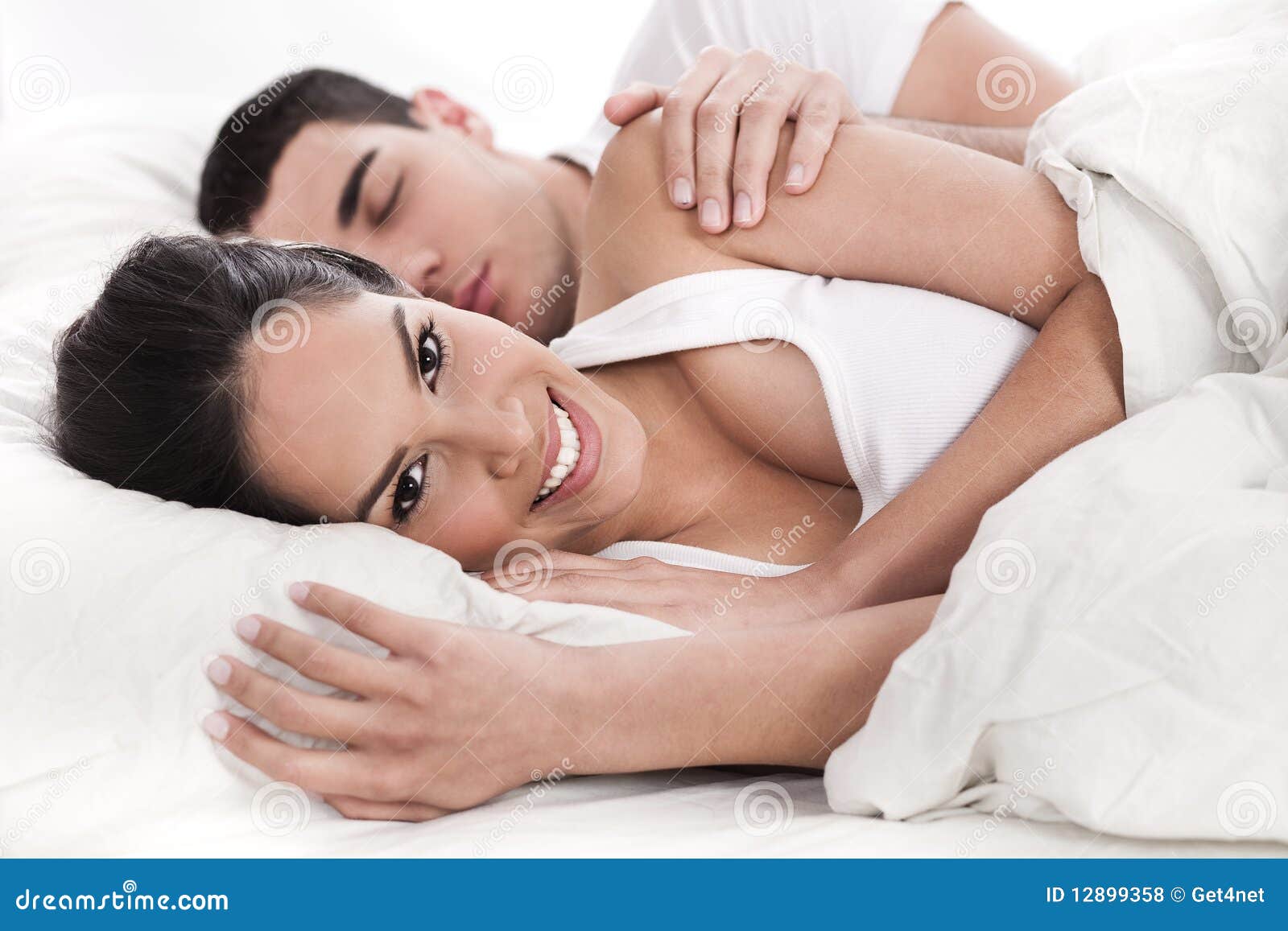 Loving Husband and Wife Lying in Bed Stock Photo image