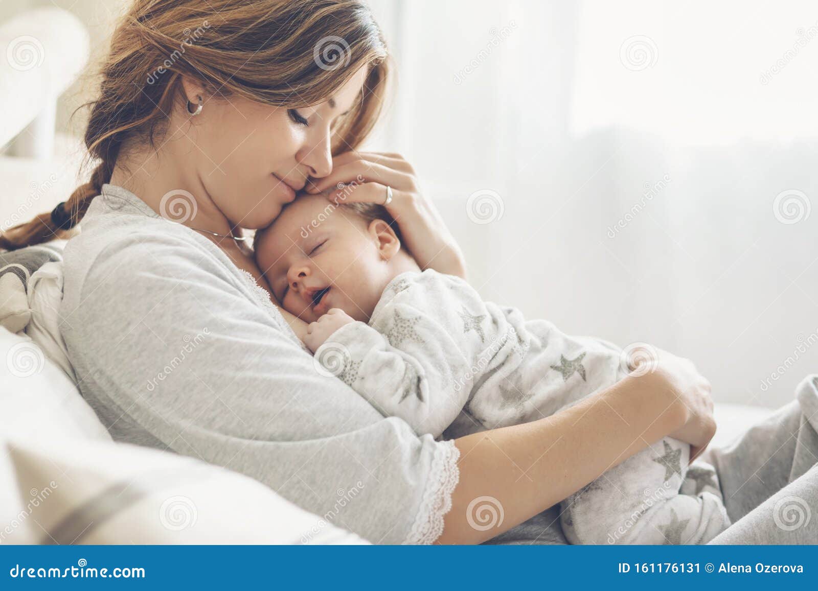 loving mom carying of her newborn baby at home