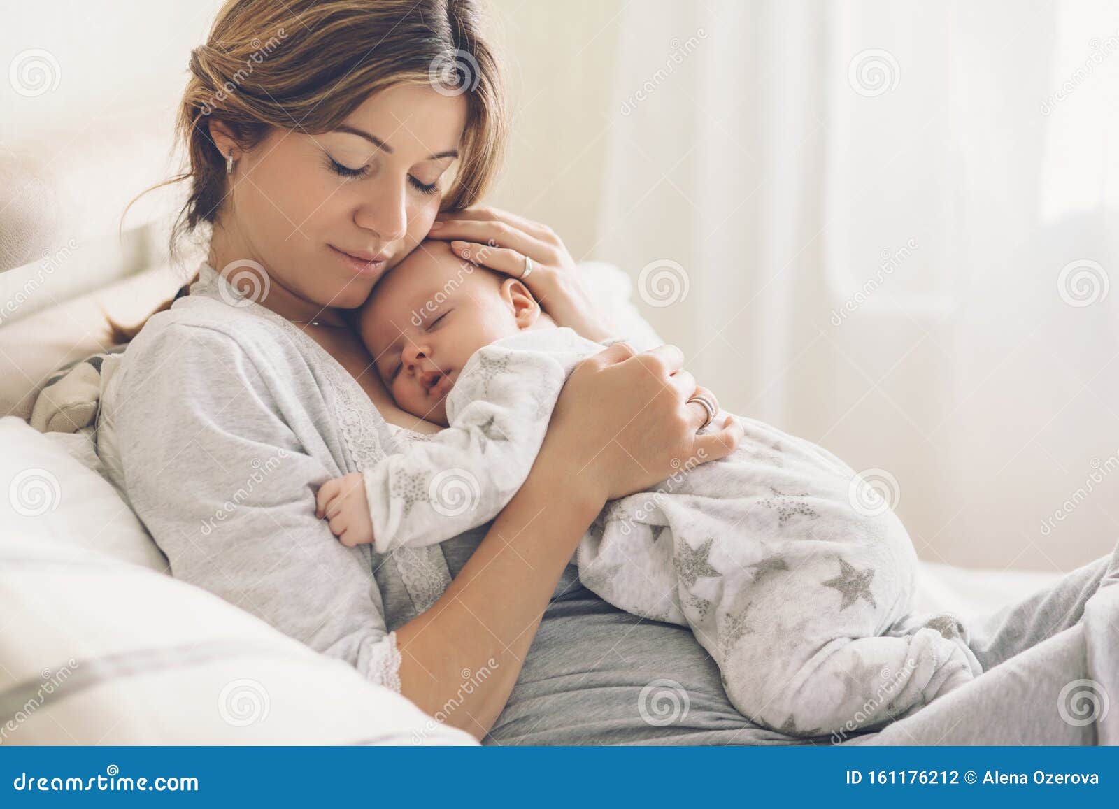 loving mom carying of her newborn baby at home