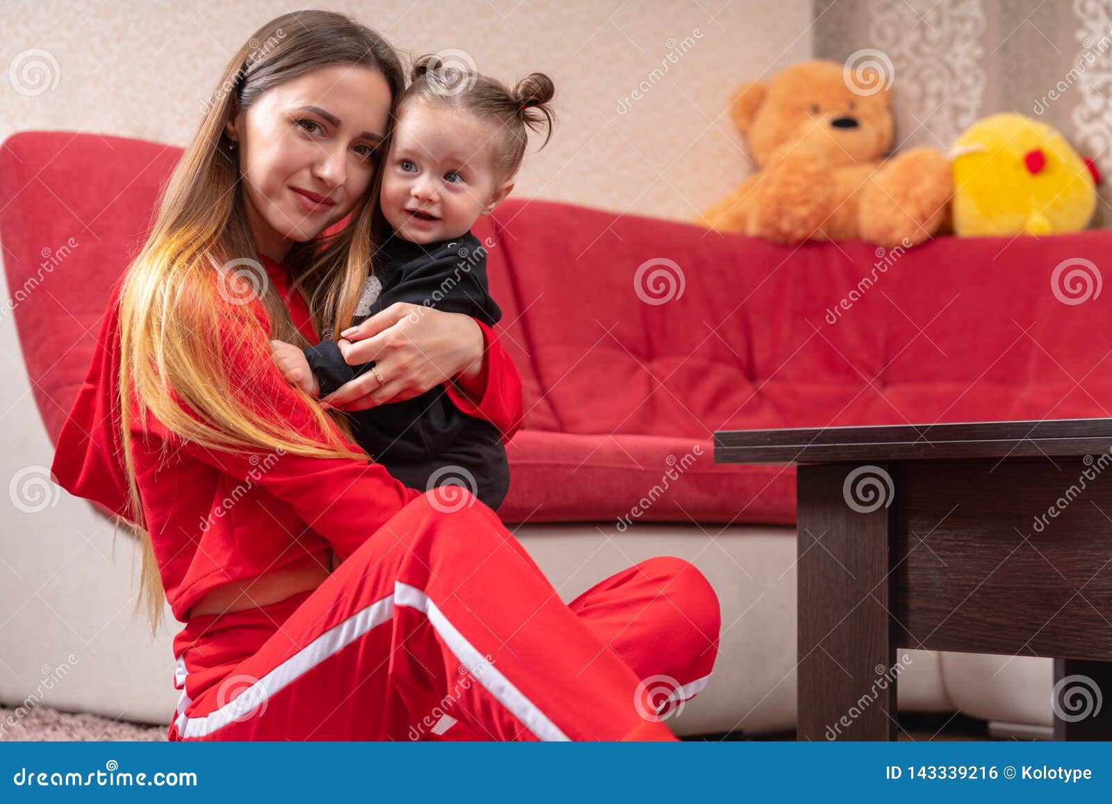 Download Loving Mother Hugging Her Happy Little Daughter Stock Photo - Image of home, family: 143339216