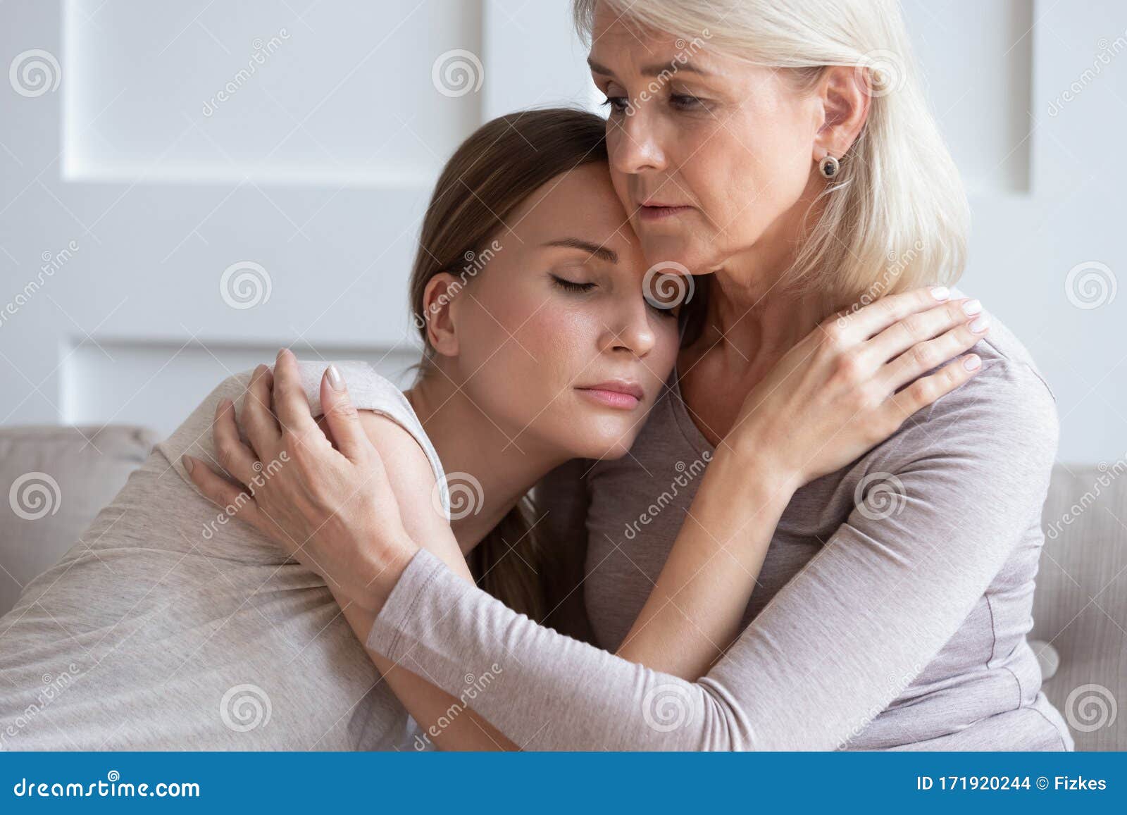 loving senior mother hug adult daughter showing support