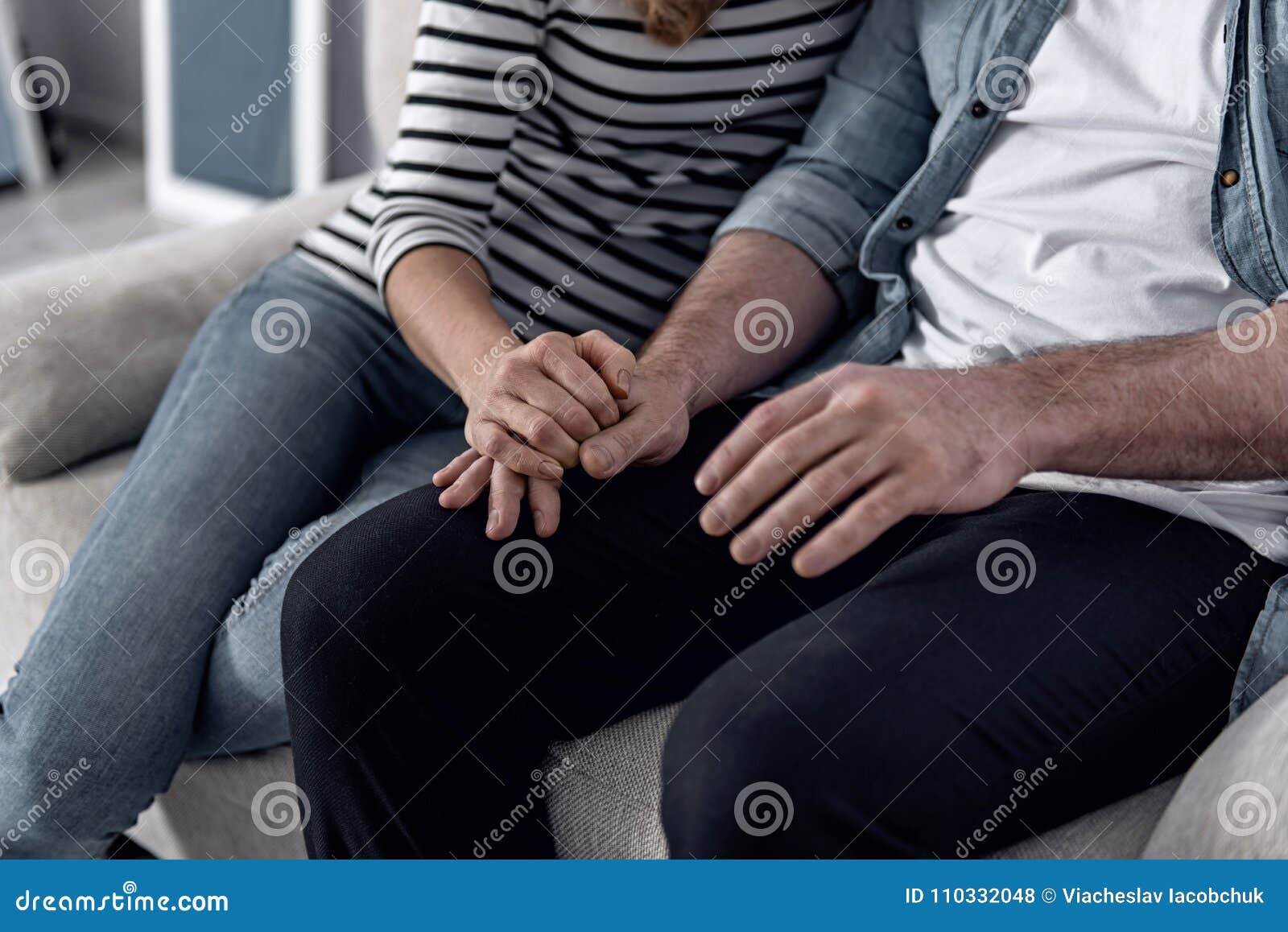 Loving Wife Holding A Hand Of Her Husband While Sitting With Him Royalty Free Stock Image 