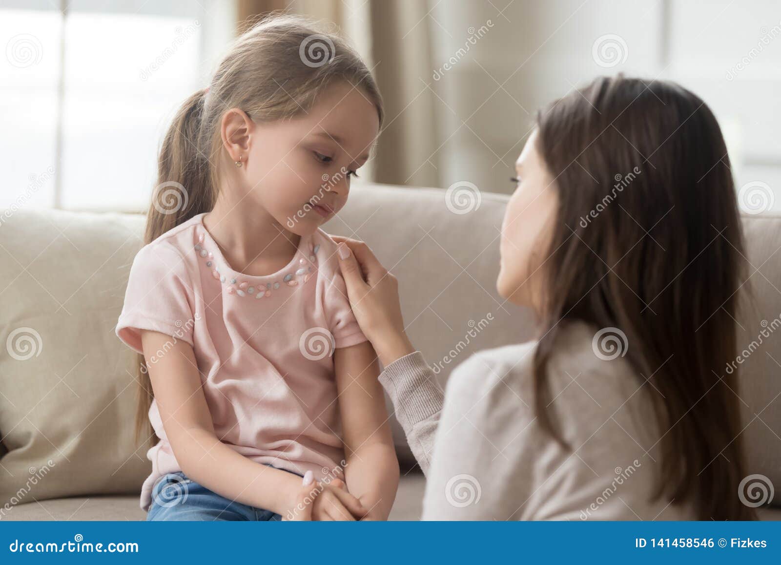 loving mom talking to upset little child girl giving support