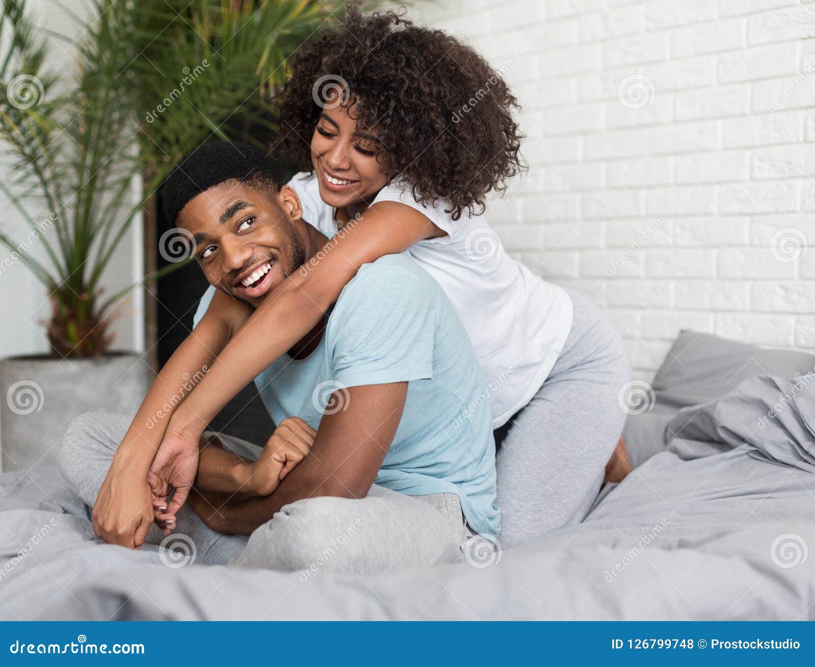 Loving Young Black Couple Embracing in Bed Stock Photo - Image of