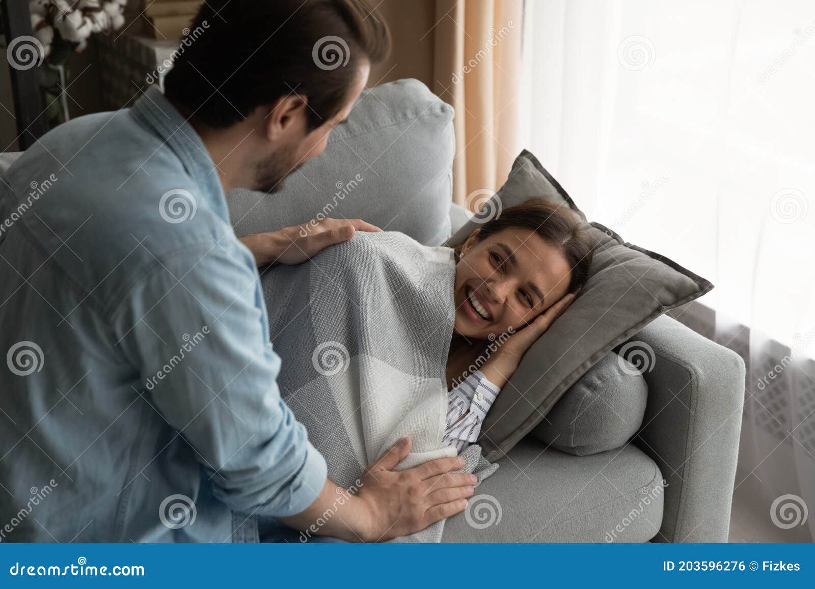 Caring Husband Take Care Of Wife Sleeping On Couch Stock Photo Image caring-husband-take-care-of-wife-sleeping-on-couch-stock-photo-image