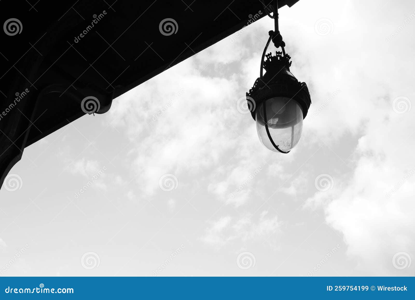 Lowangle Monochrome Shot of the Street Light Hanging from the Building