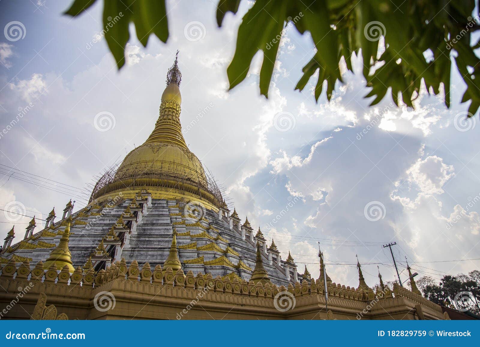 low angle shot of mahazedi pagoda against a cloudy sky