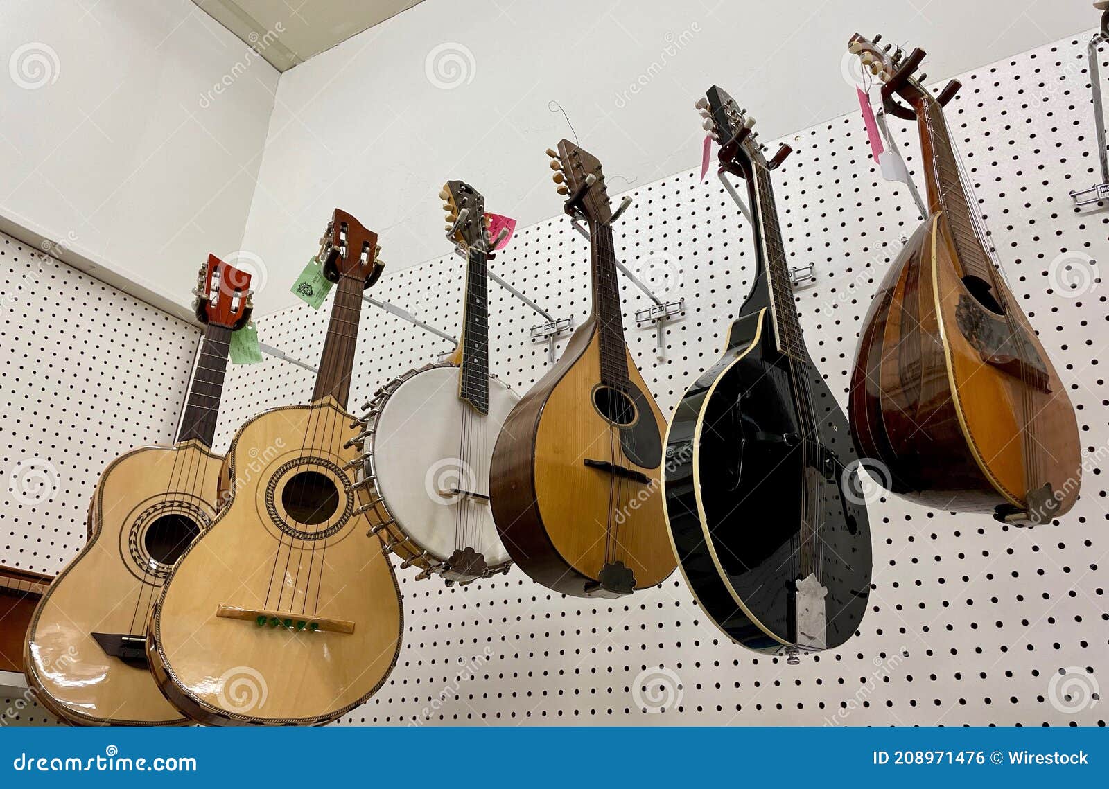 Low Angle Shot of Some Different Stringed Instruments Hanging from the