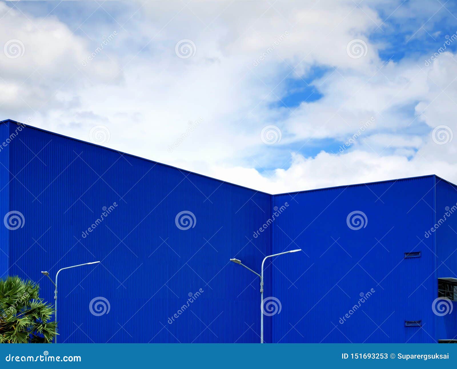 Blue Warehouse Building Exterior Against Blue Cloudy Sky Stock Image ...