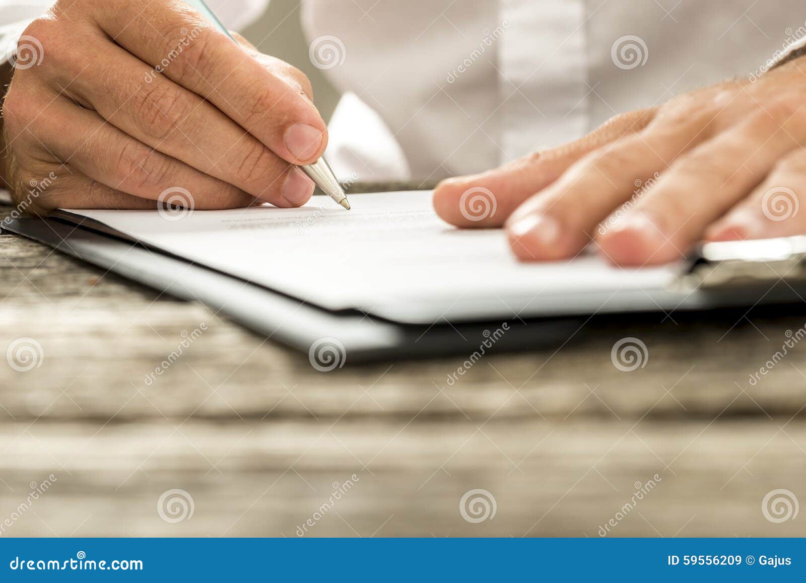 low angle view of male hand signing contract or subscription for