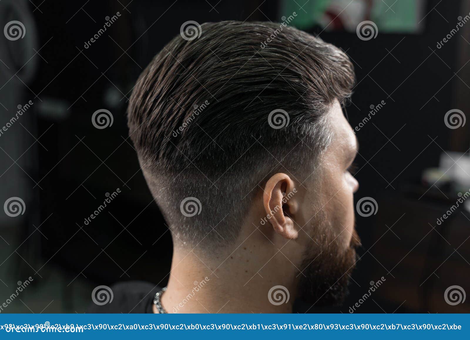 low fade machine haircut for handsome bearded man in barbershop. hair cut with a smooth transition.