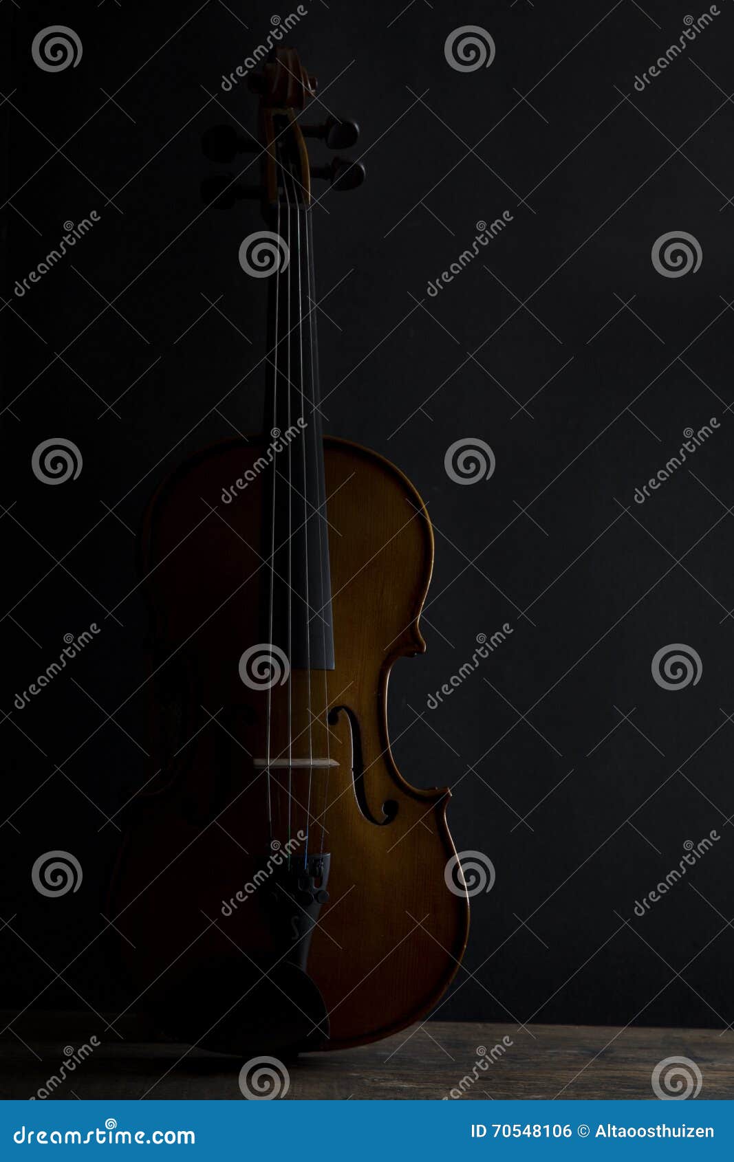Low Key Violin in Vertical Position with Side Lighting Stock Photo