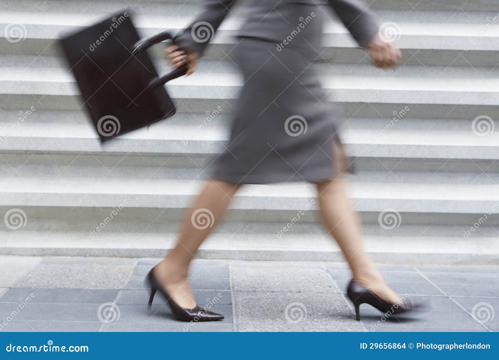 low section of businesswoman walking