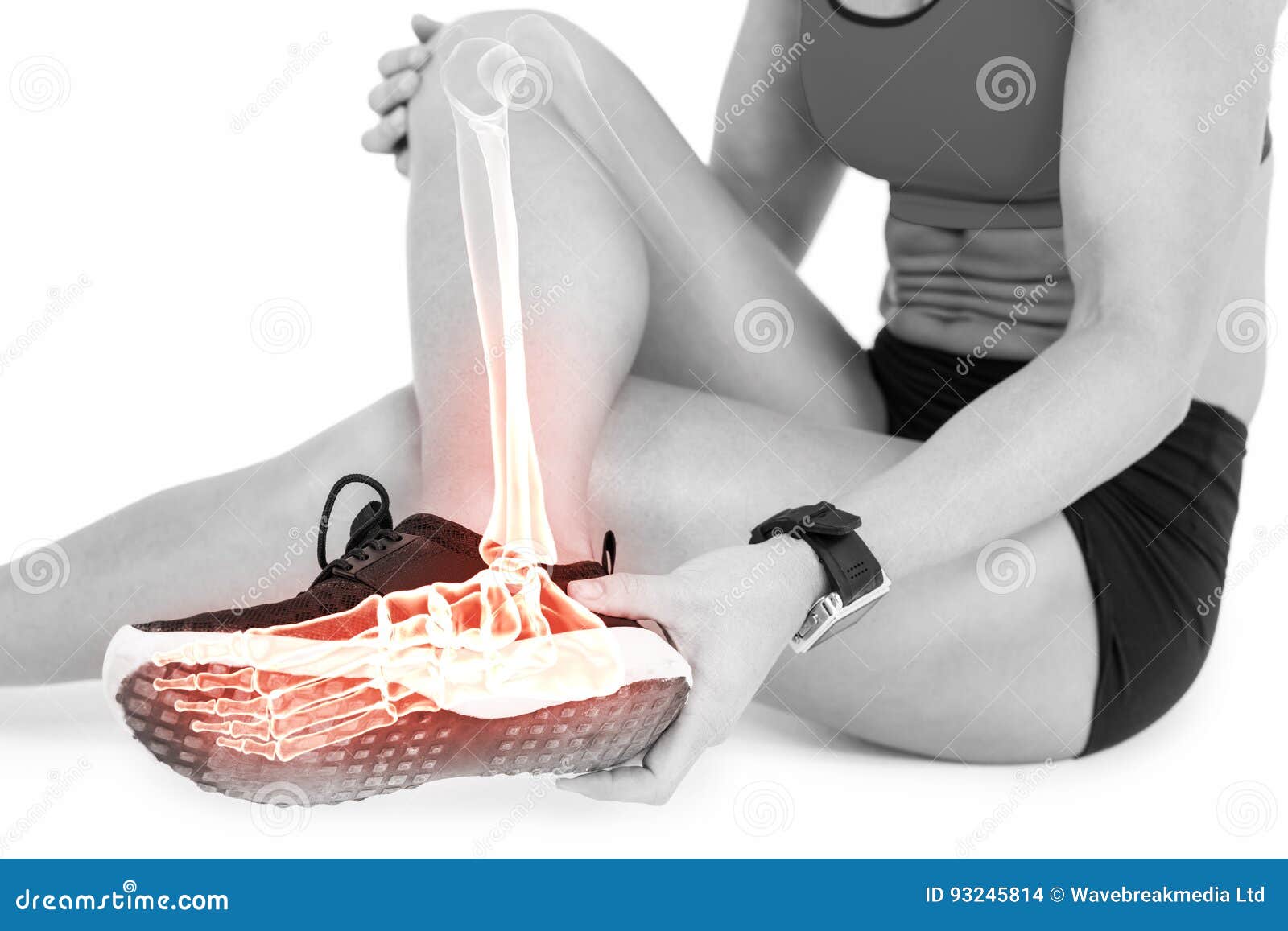 low section of female athlete suffering from ankle pain on white background