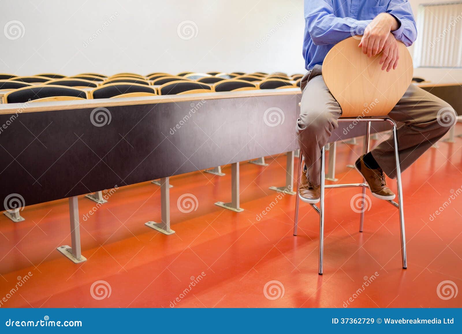 low section of a teacher on chair in lecture hall