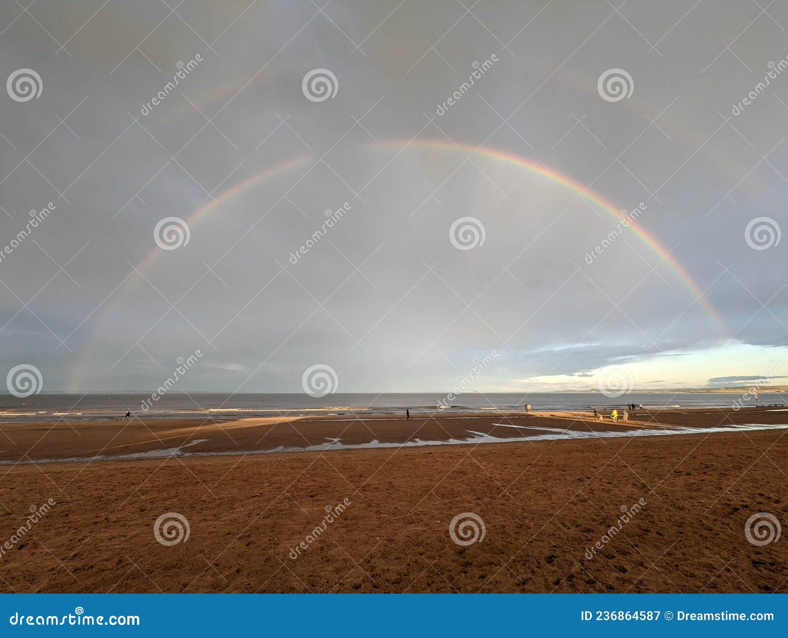 Low Tide at Beach with Double Rainbow Stock Image Image of reflection