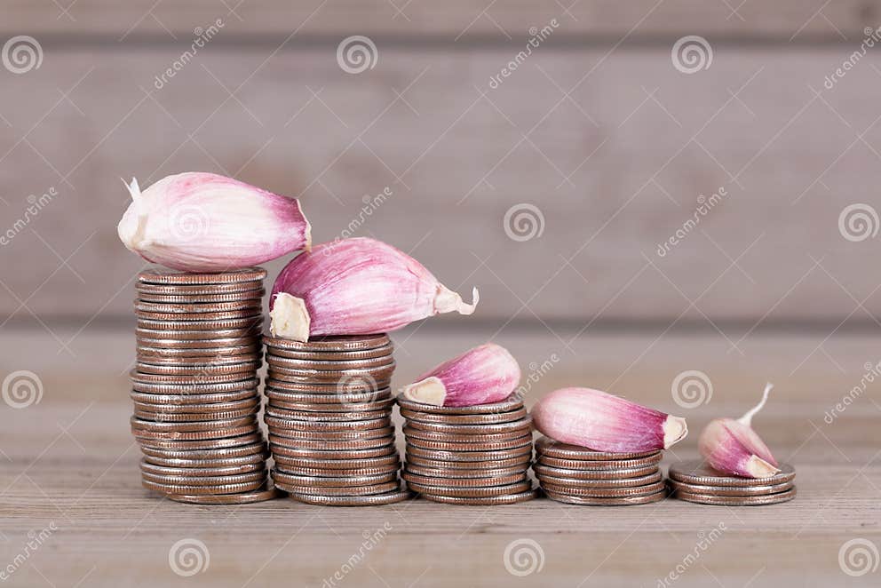 Lower Garlic Prices and Coins Stock Photo Image of items, objects