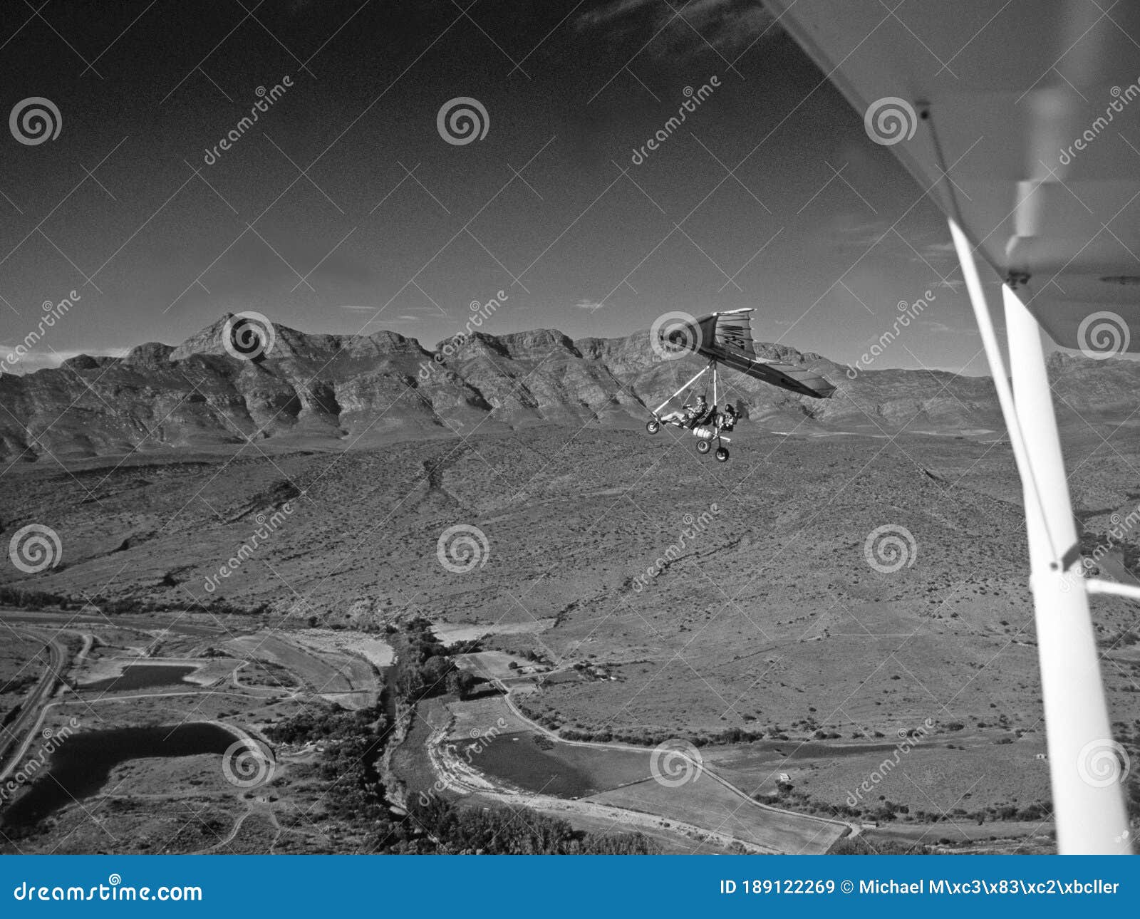 south africa: hangglider over the swartberg-mountains in the little karoo