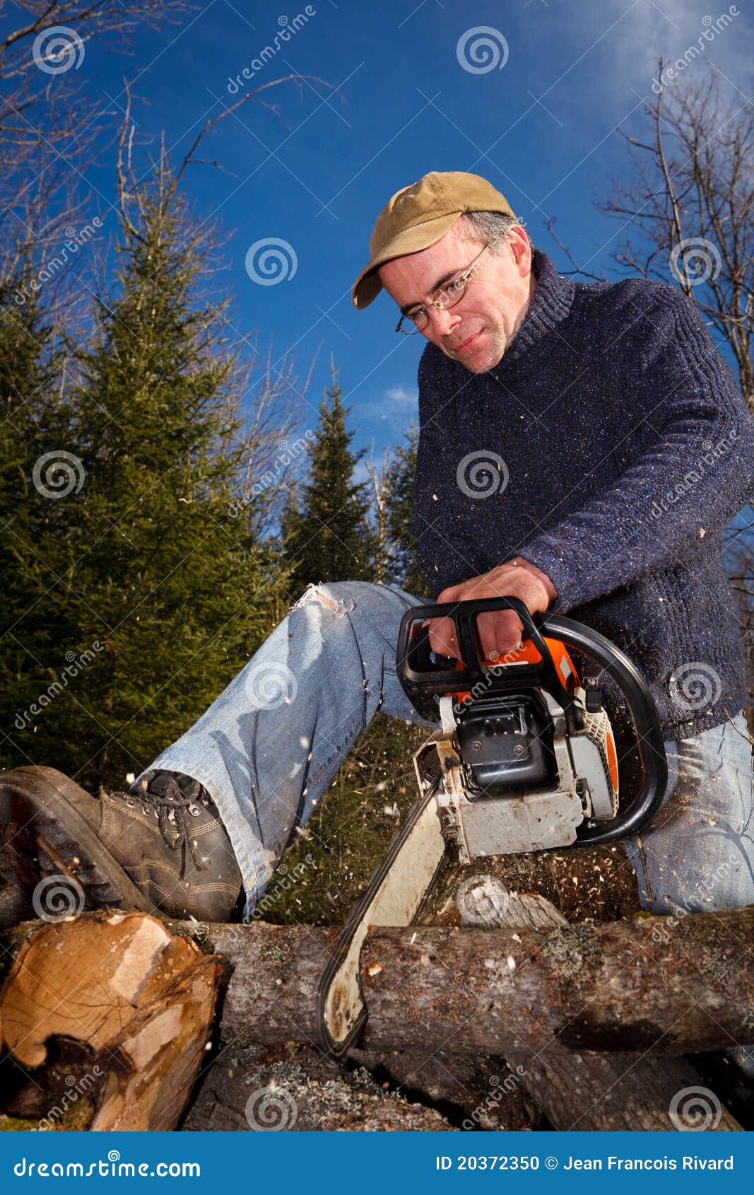 A Lumberjack is Using a Chainsaw. Stock Photo Image of gear, industry