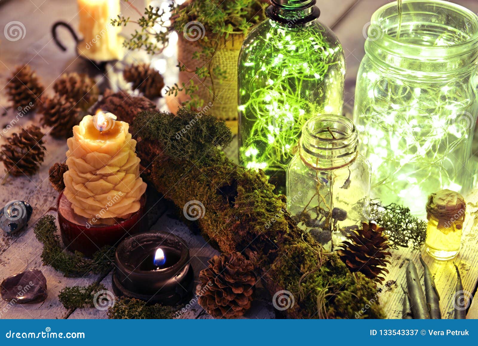 Luminous Bottles with Lights and Burning Candle with Nature Elements