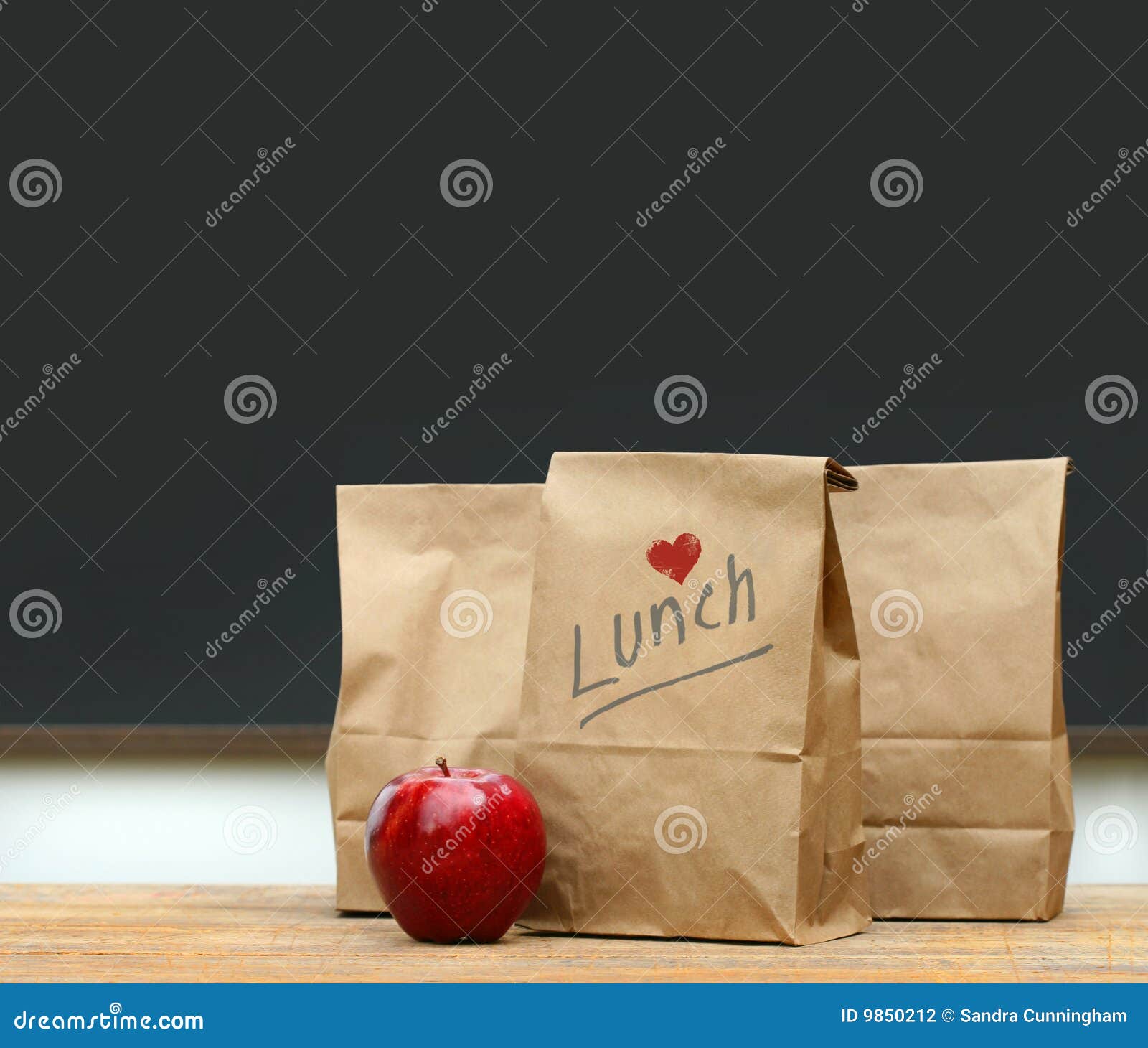 lunch bags with apple on school desk