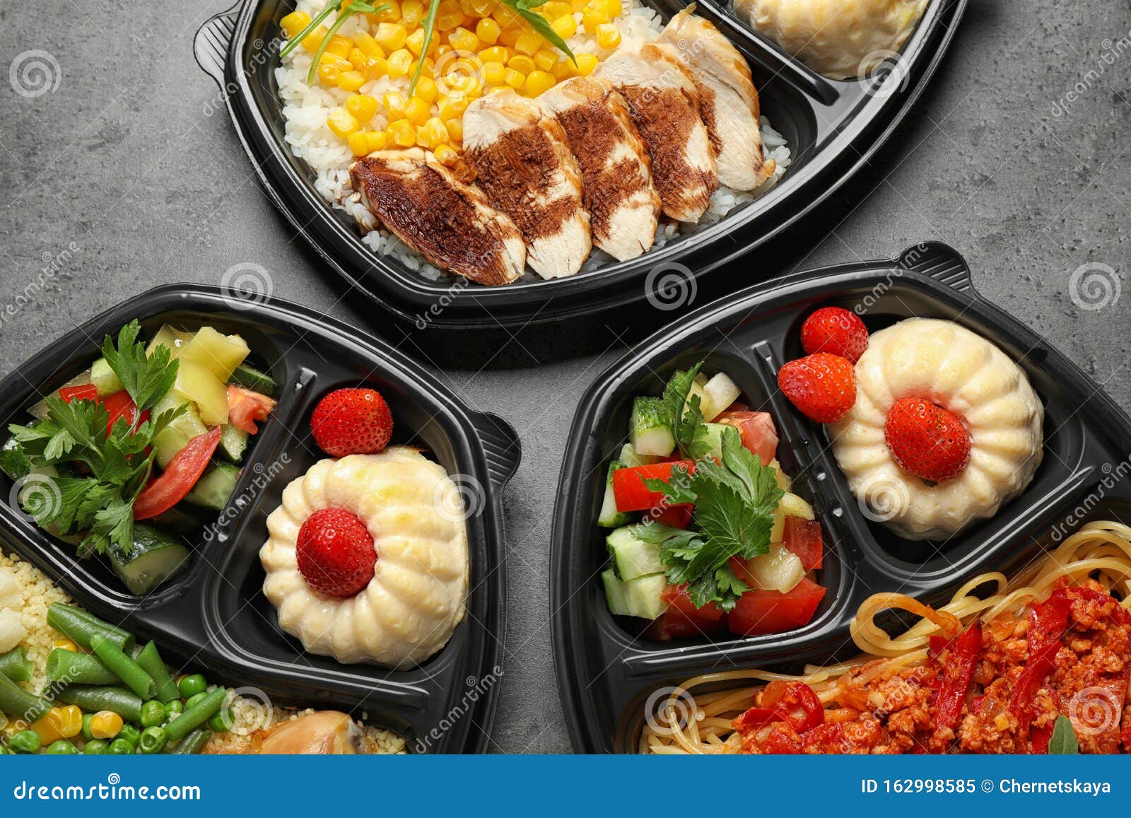 Lunchboxes with Different Meals on Grey Table. Healthy Food Delivery
