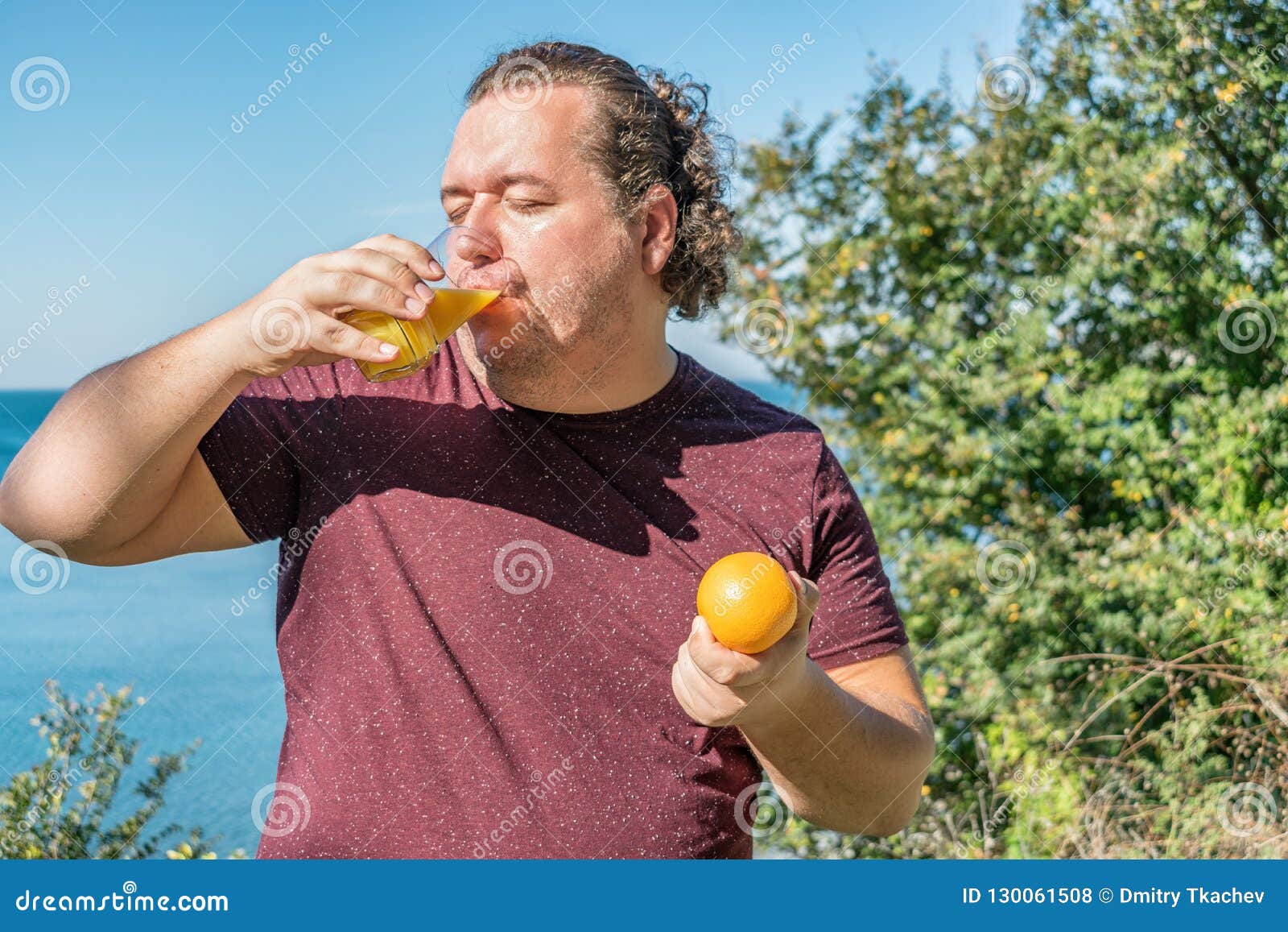 Lustiger dicker Mann auf den trinkenden Saft- und Früchten des Ozeans essen Ferien, Gewichtsverlust und gesunde Ernährung