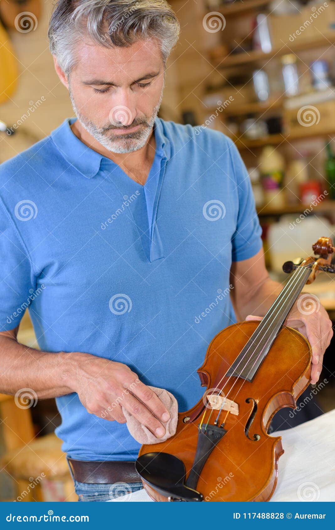 Luthier Polishing New Violin in Stock Photo Image of