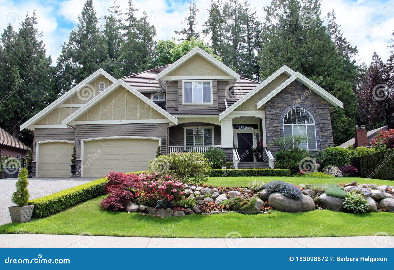 luxurious canadian mansion with a large professionally landscaped front yard