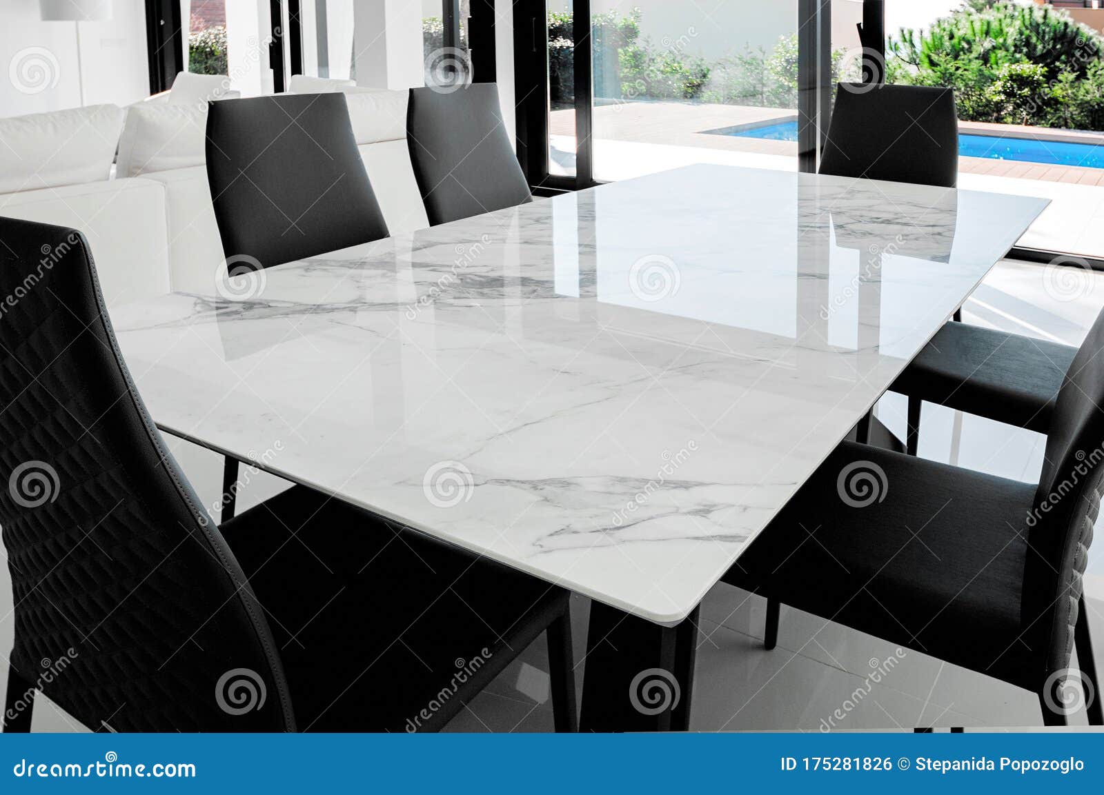 Luxurious Marble Dining Table With Black Chairs Stock Photo