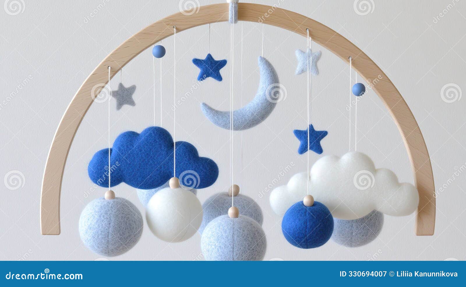 a luxury baby mobile showcases hand-sewn wool felt in soft colors, featuring playful clouds, stars, and moon, elegantly
