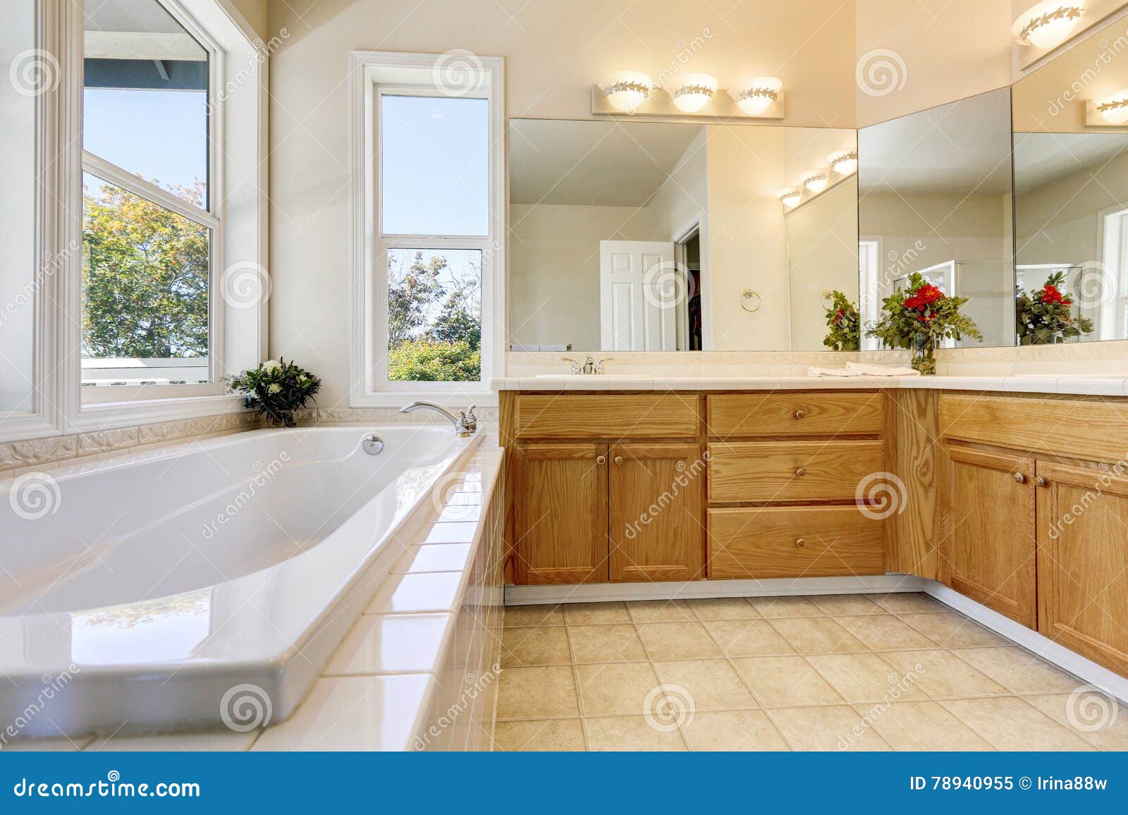 Luxury Bathroom Interior With Wooden Cabinets And White Bathtub
