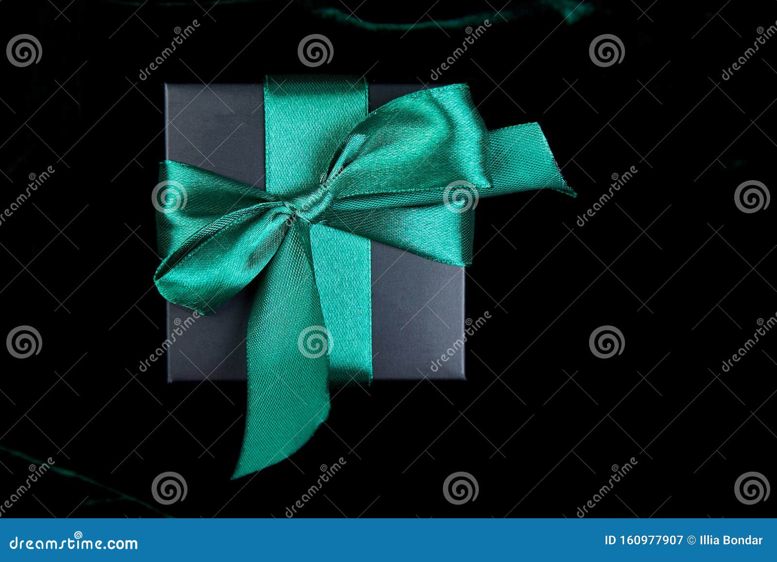 Luxury black gift boxes with green ribbon Stock Photo by bondarillia