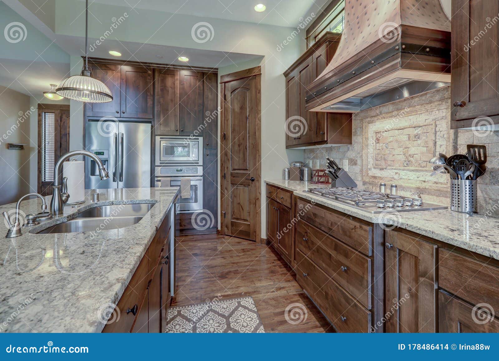 Luxury Dark Wood Rich Kitchen Interior With Copper Stove Hood And Grey Natural Stone Backsplash Stock Photo Image Of Modern Design 178486414