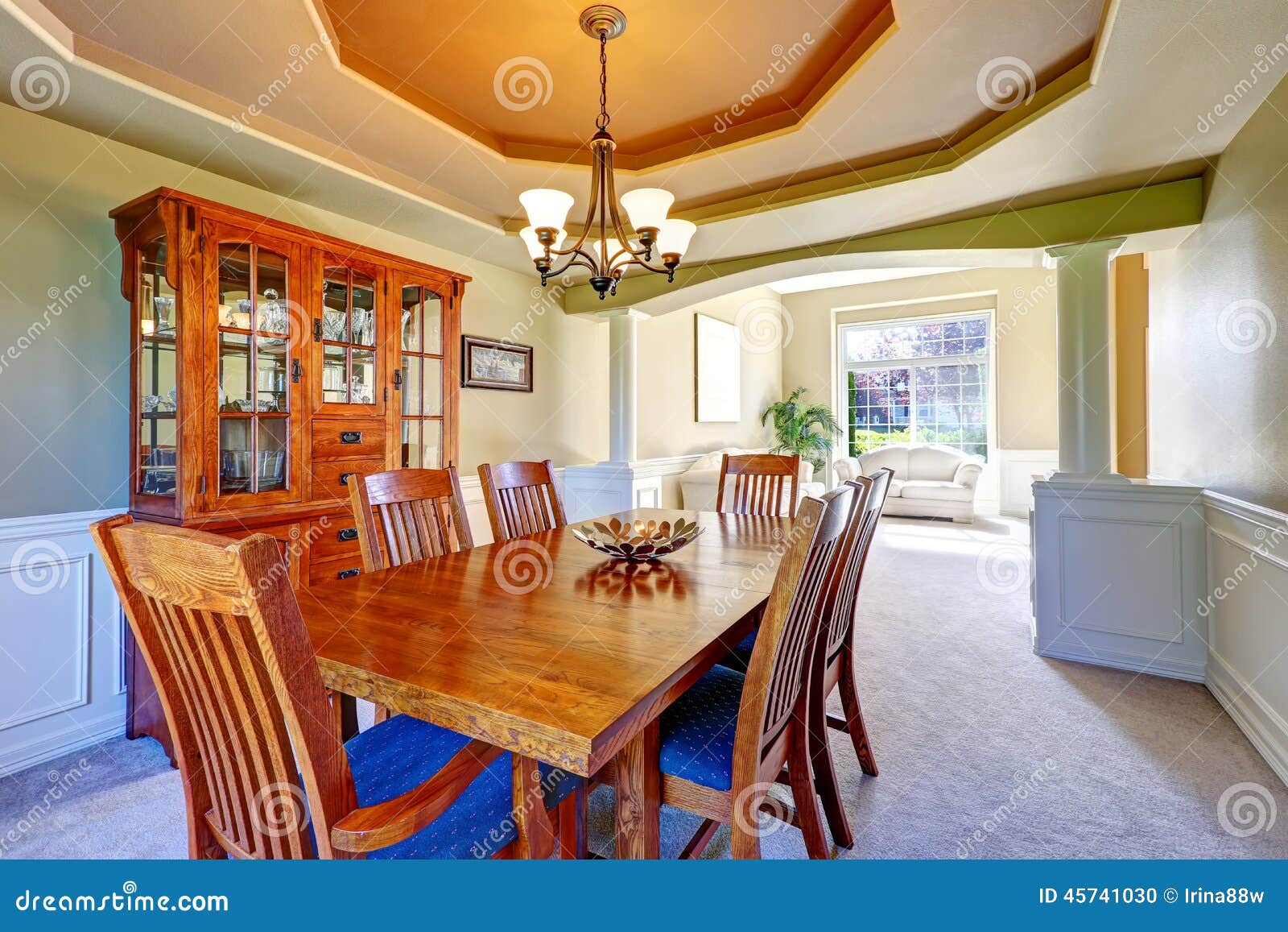 Luxury Dining Room With White Columns And Coffered Ceiling