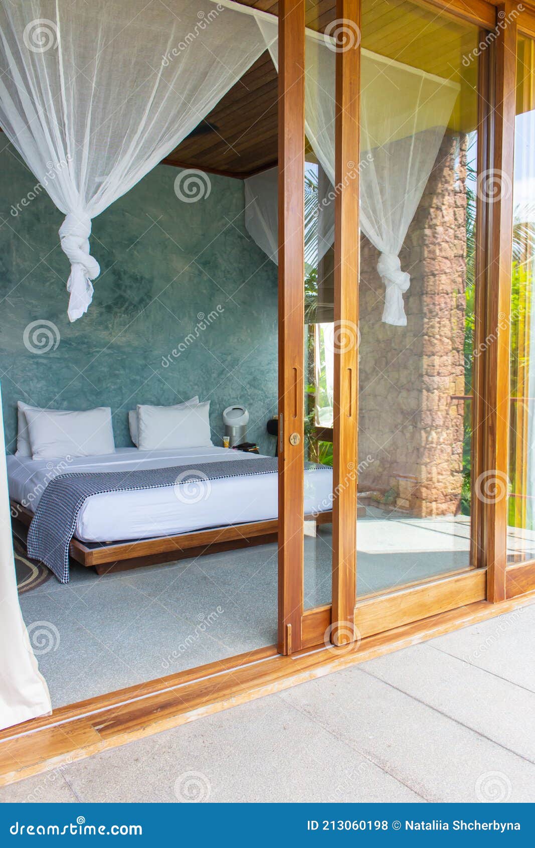 Luxury Hotel Room with Mosquito Net and Open Doorway. Comfortable Interior  of Tropical Hotel. Cozy and Elegant Bedroom Design Stock Photo - Image of  decoration, exotic: 213060198