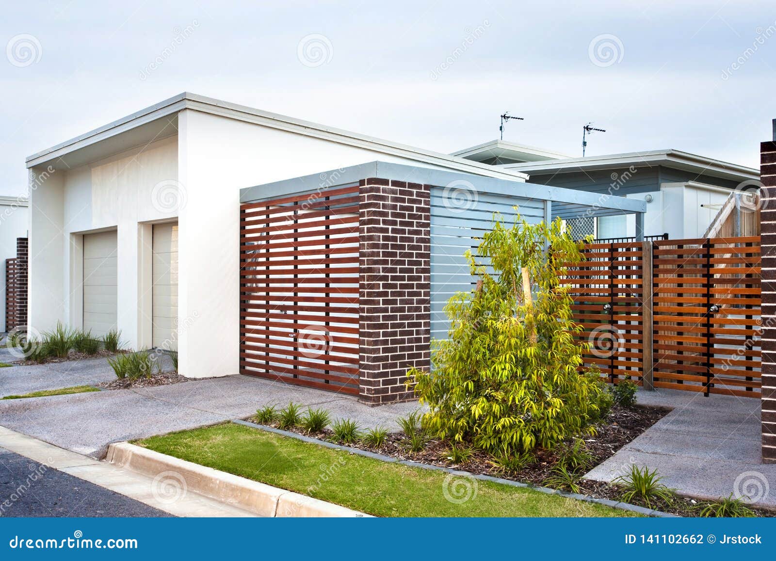 Luxury House Front Side with Wooden Gate and Garden Stock Photo - Image