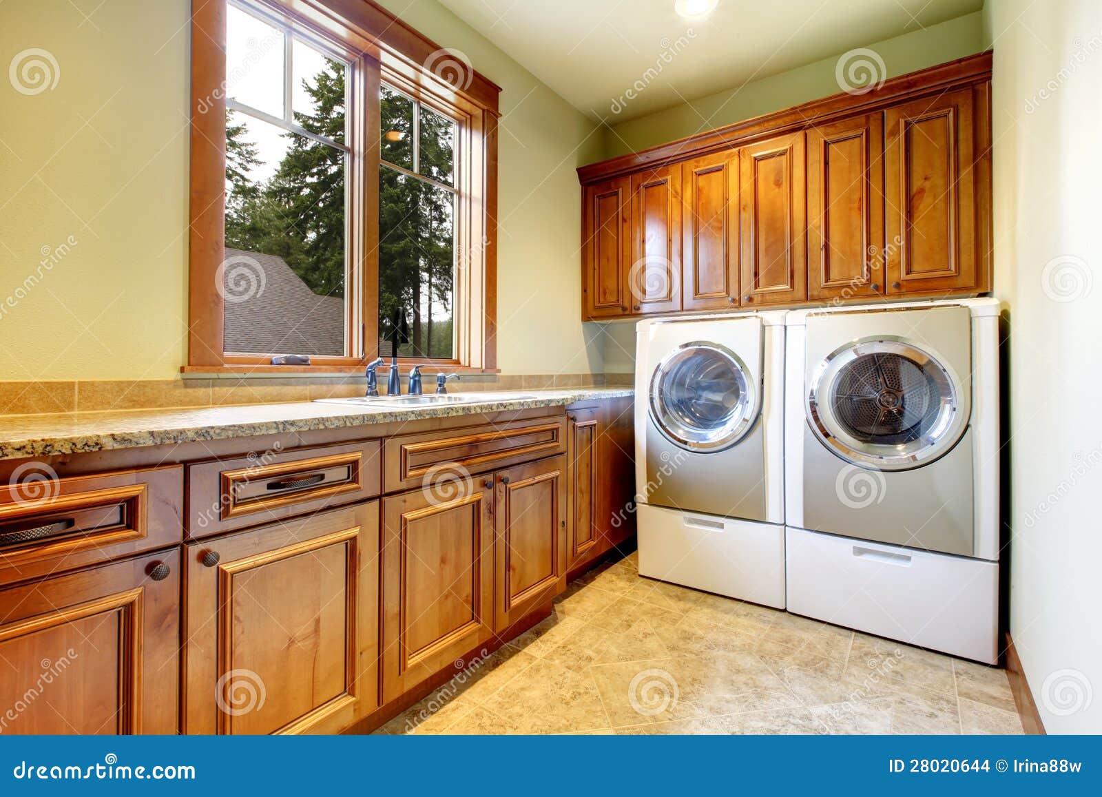 luxury laundry room with wood cabinets.