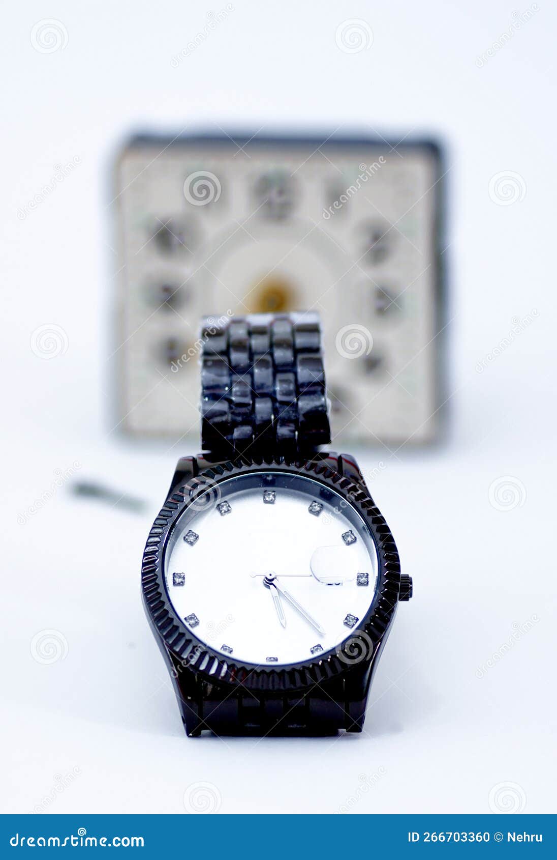 luxury men  watchin front of vintage alarm clock . time concept