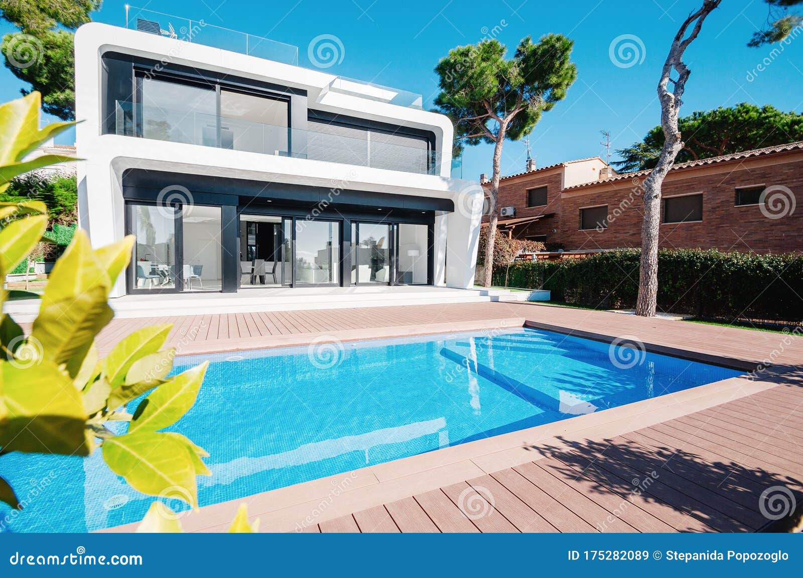 Luxury Modern White House With Large Windows Overlooking A Mediterian Landscaped Garden With Palm Trees And Blue Swimming Pool Stock Image Image Of House Contemporary 175282089