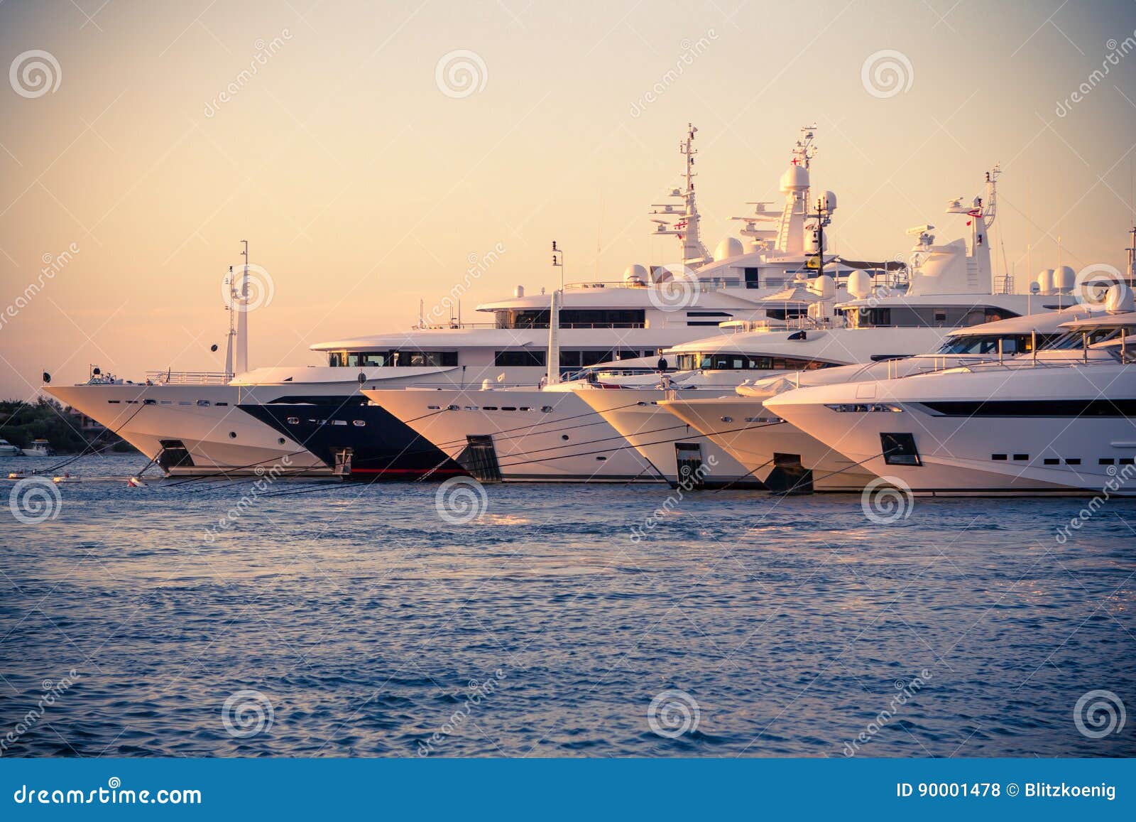 luxury, rich yachts moored in a harbor of porto cervo