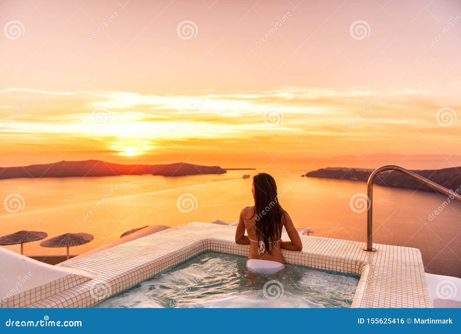 Luxury Travel Santorini Vacation Woman Swimming in Hotel Jacuzzi