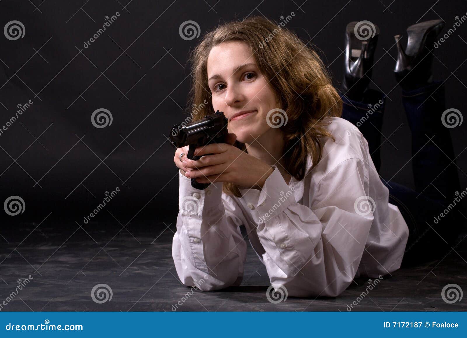lying woman with gun
