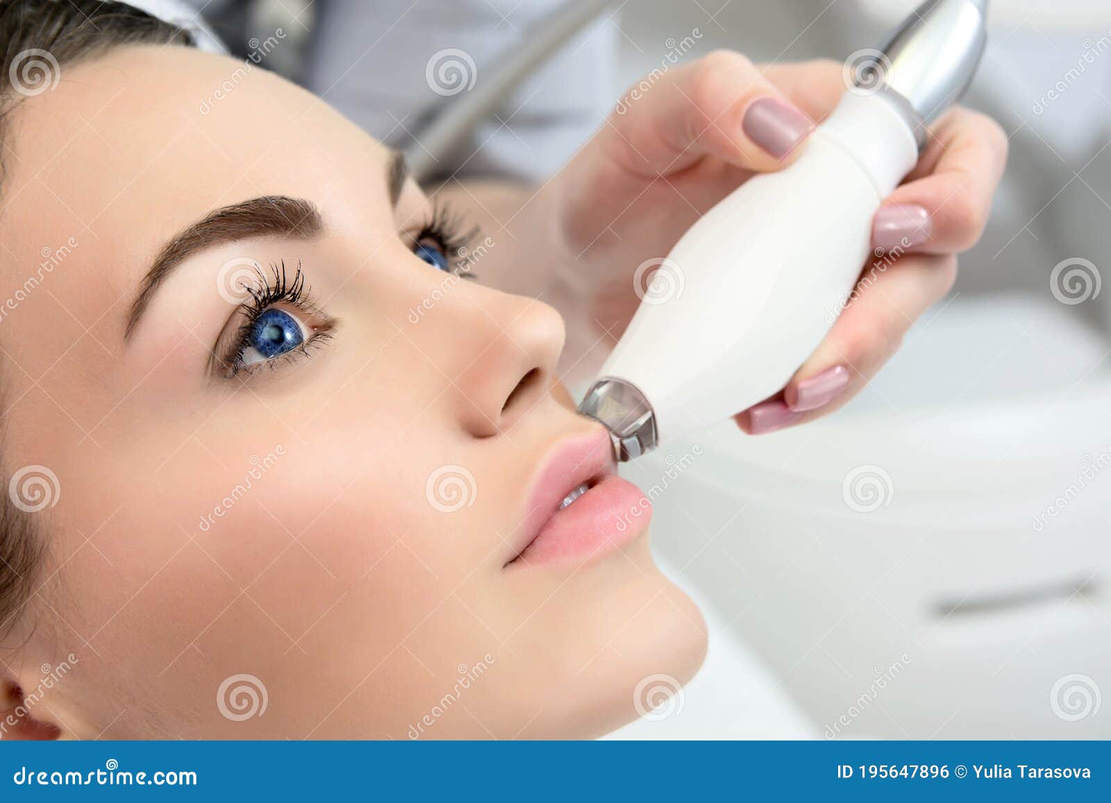 Therapist Beautician Makes A Rejuvenating Facial Massage For The Model By Lpg Apparatus In A