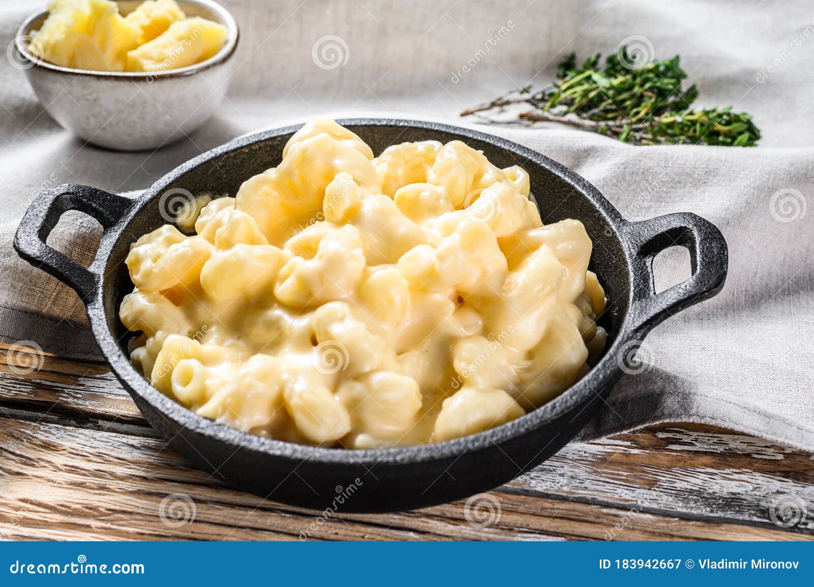 mac and cheese, american style macaroni pasta in cheesy sauce. white wooden background. top view