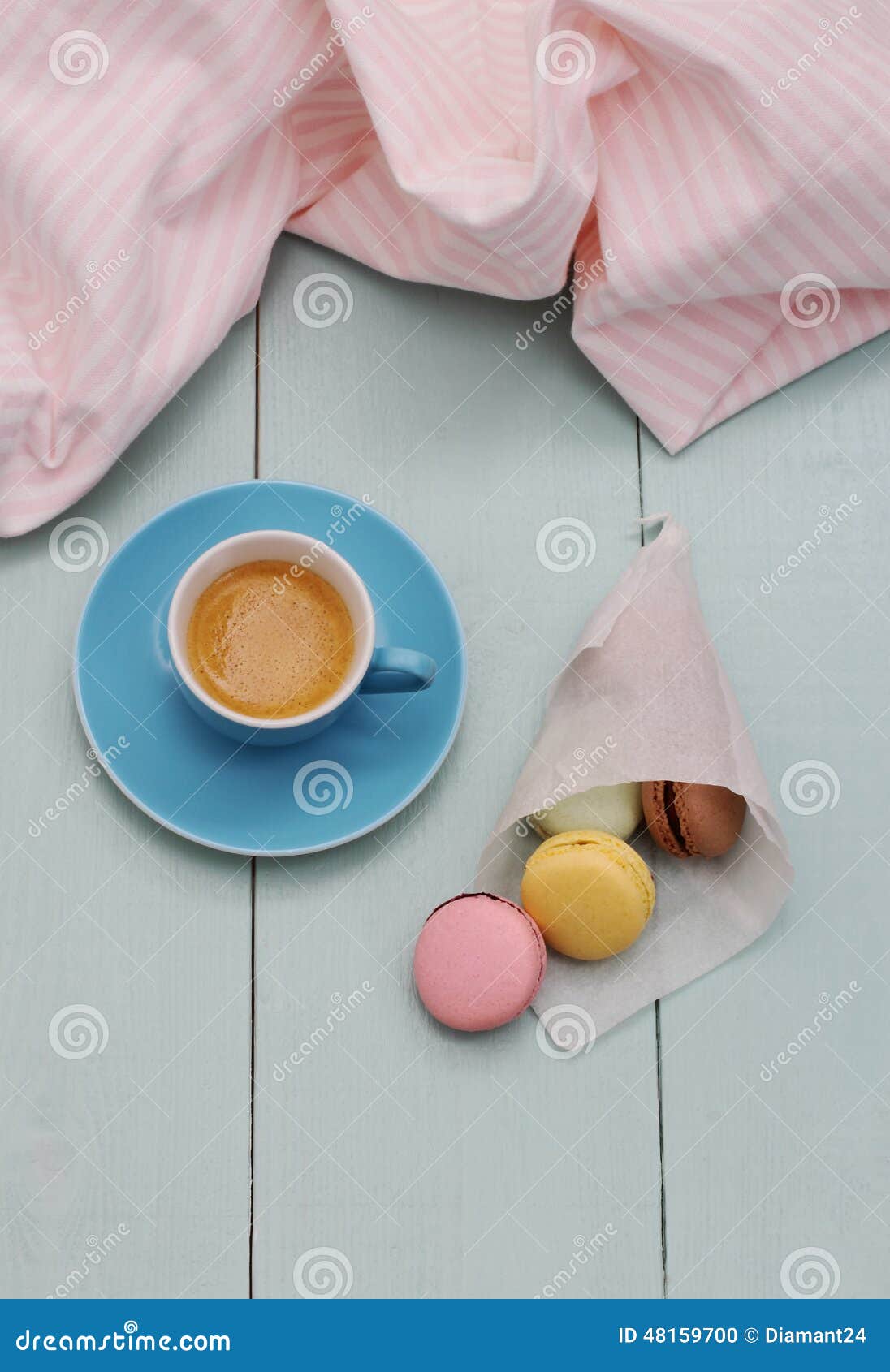Macarons in Backing Paper and Blue Espresso Cup Stock Photo