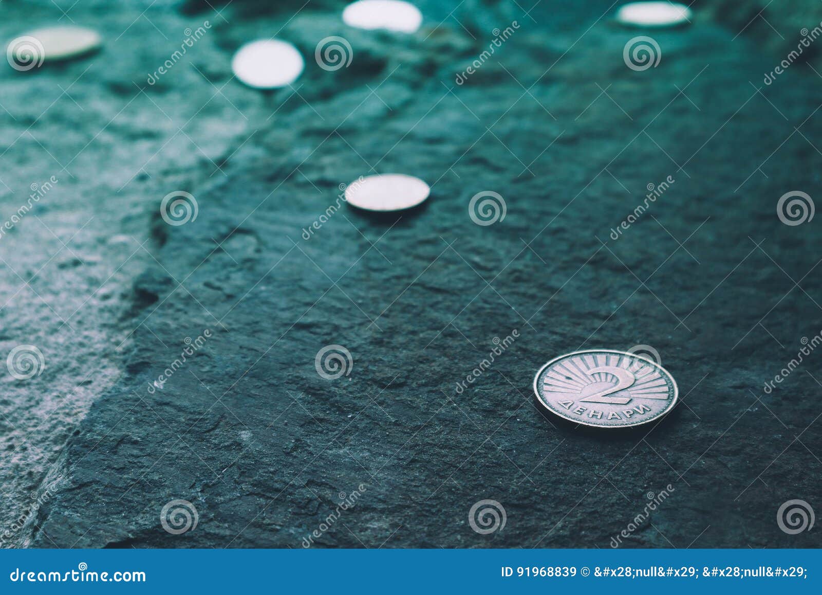 macedonia currency two denar on the stone background. photo depicts macedonian valuta shiny denari metal coins, close up, macro v