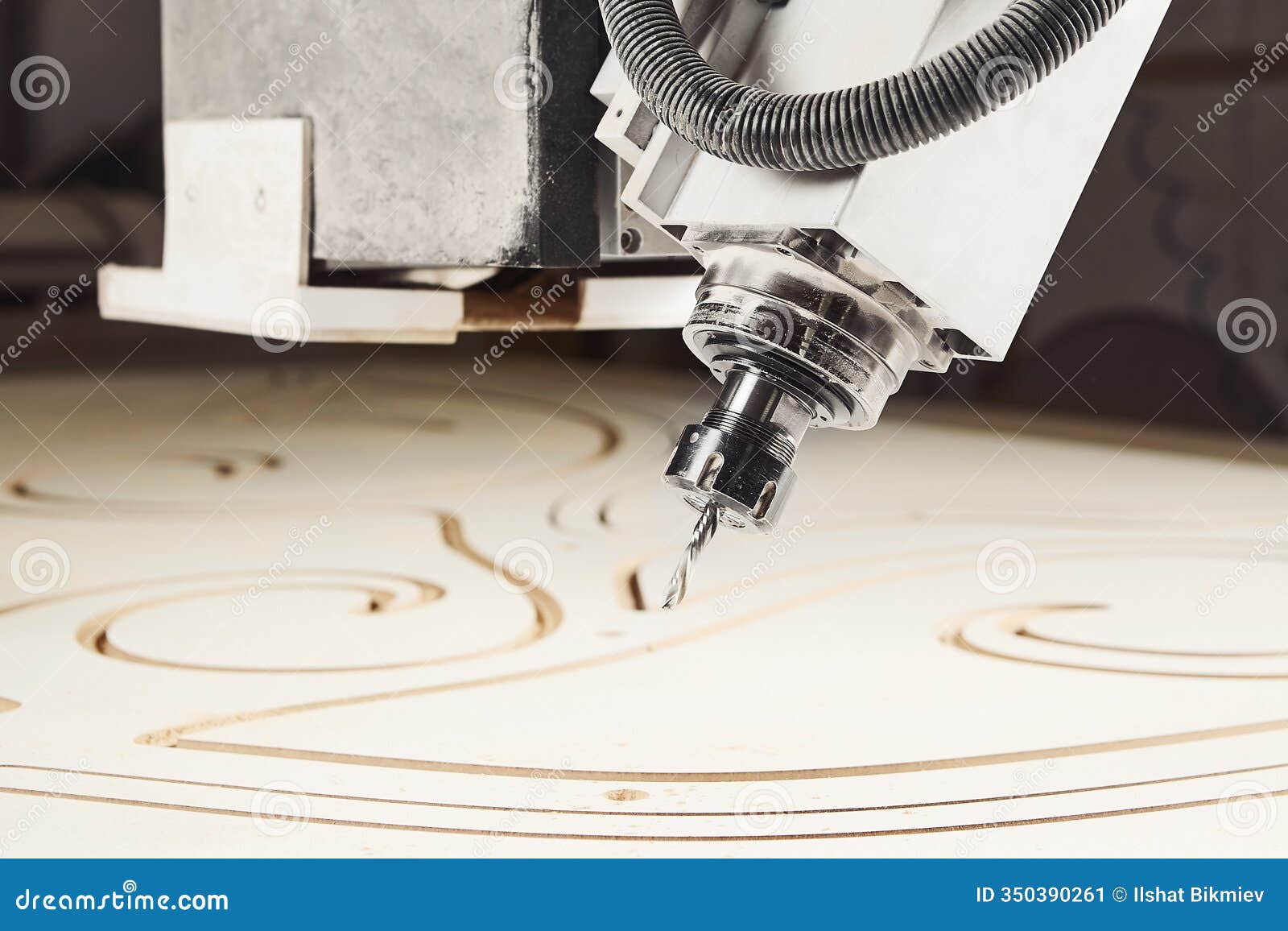 machine with computer numerical control for cutting wood with various router bits.